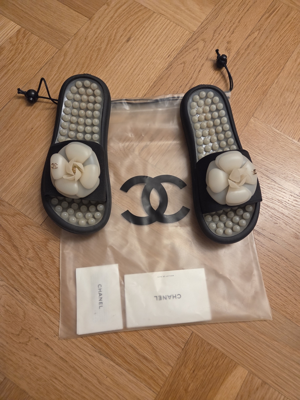 CHANEL Black Slides with Ivory Camellia Embellishments